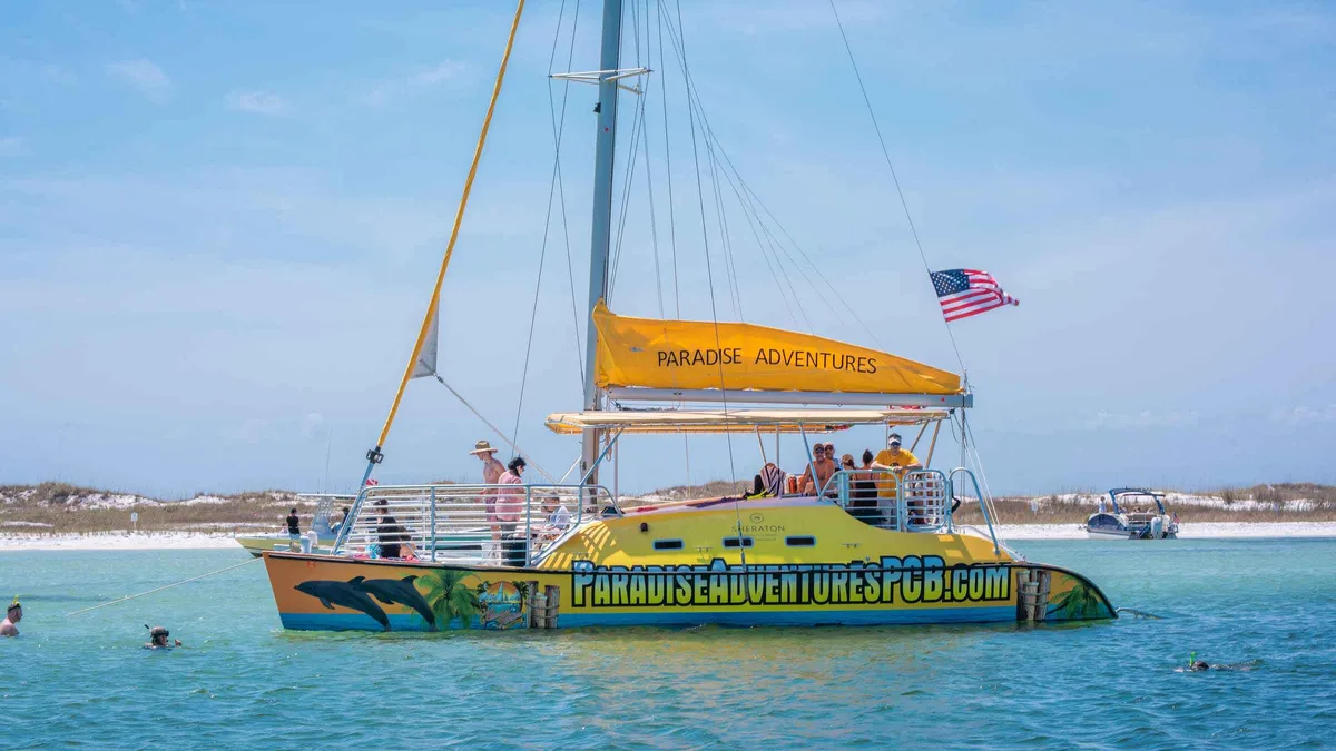 The Footloose catamaran under sail on a Shell Island dolphin tour with snorkeling from Panama City Beach, Florida